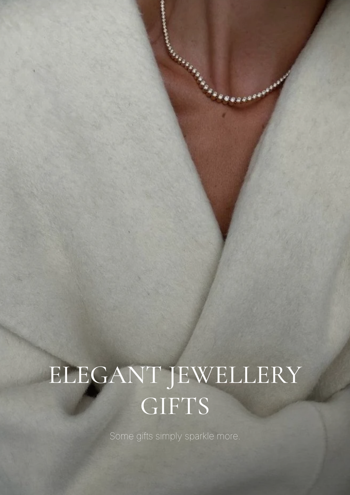 Elegant jewelry gift collection featuring gold tennis bracelets, Cuban link necklaces, huggie earrings, and bangles displayed on marble surface