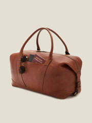 Luca Faloni full grain leather bag weekender in cognac with passport and sunglasses