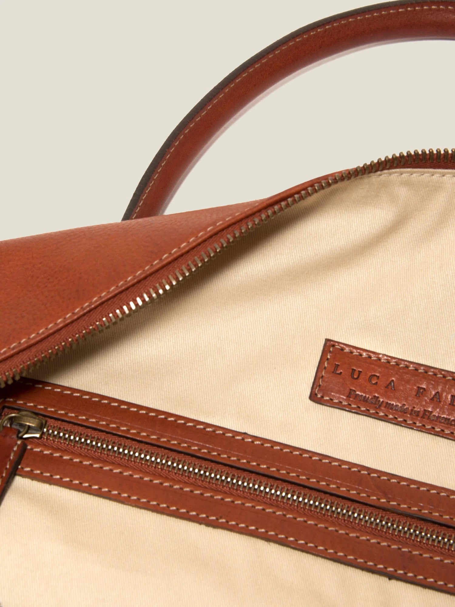 Full grain leather bag zip detail showing vegetable tanned Italian leather texture