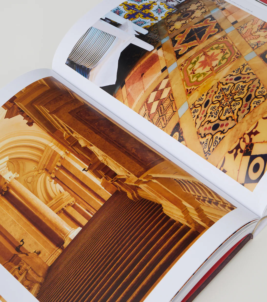 Open book displaying architectural and decorative images on a white background