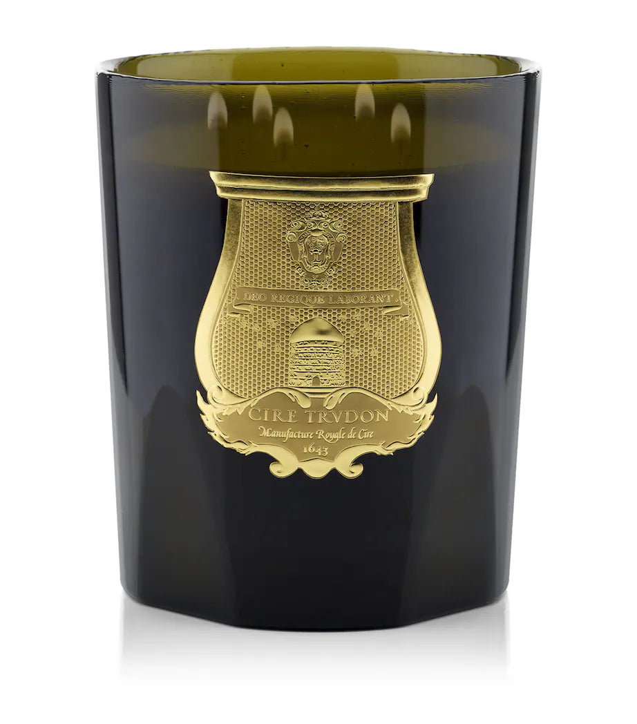 Black candle holder with gold emblem and 'Cire Trudon' branding on a white background
