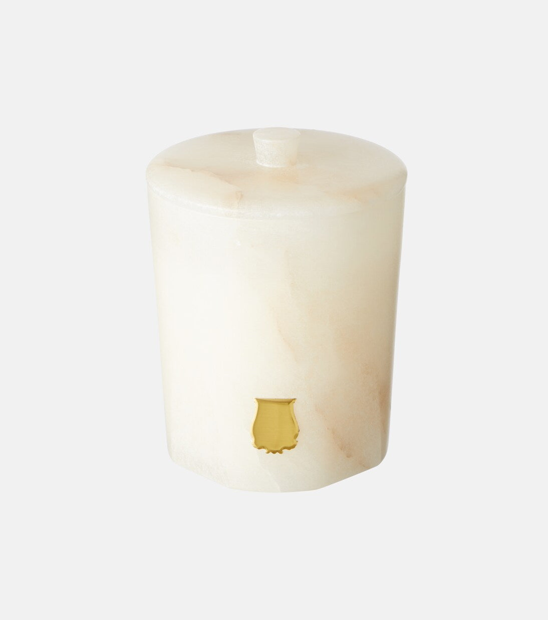 White candle with a gold emblem on a white background