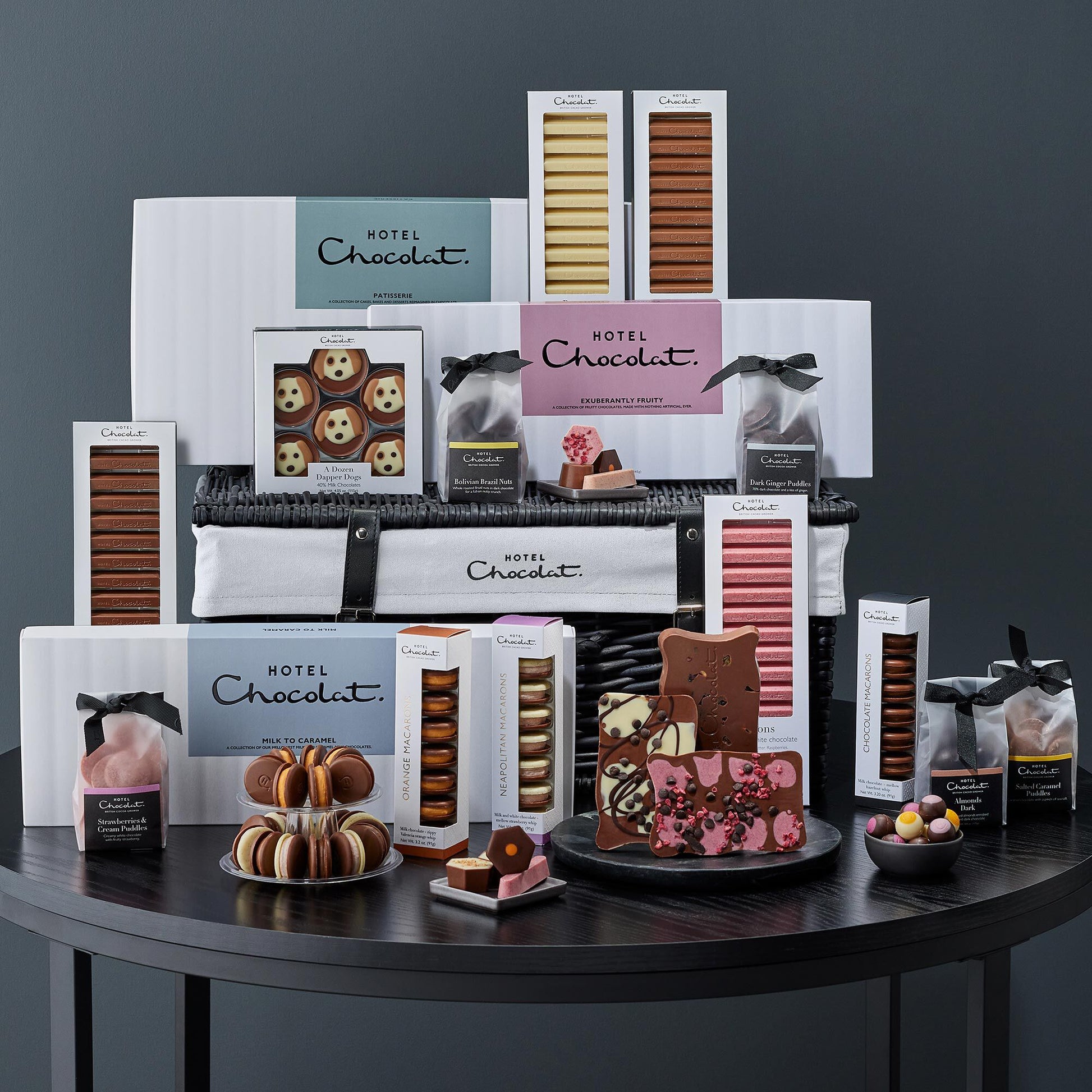 Assorted Hotel Chocolat products on a dark surface with a gray background