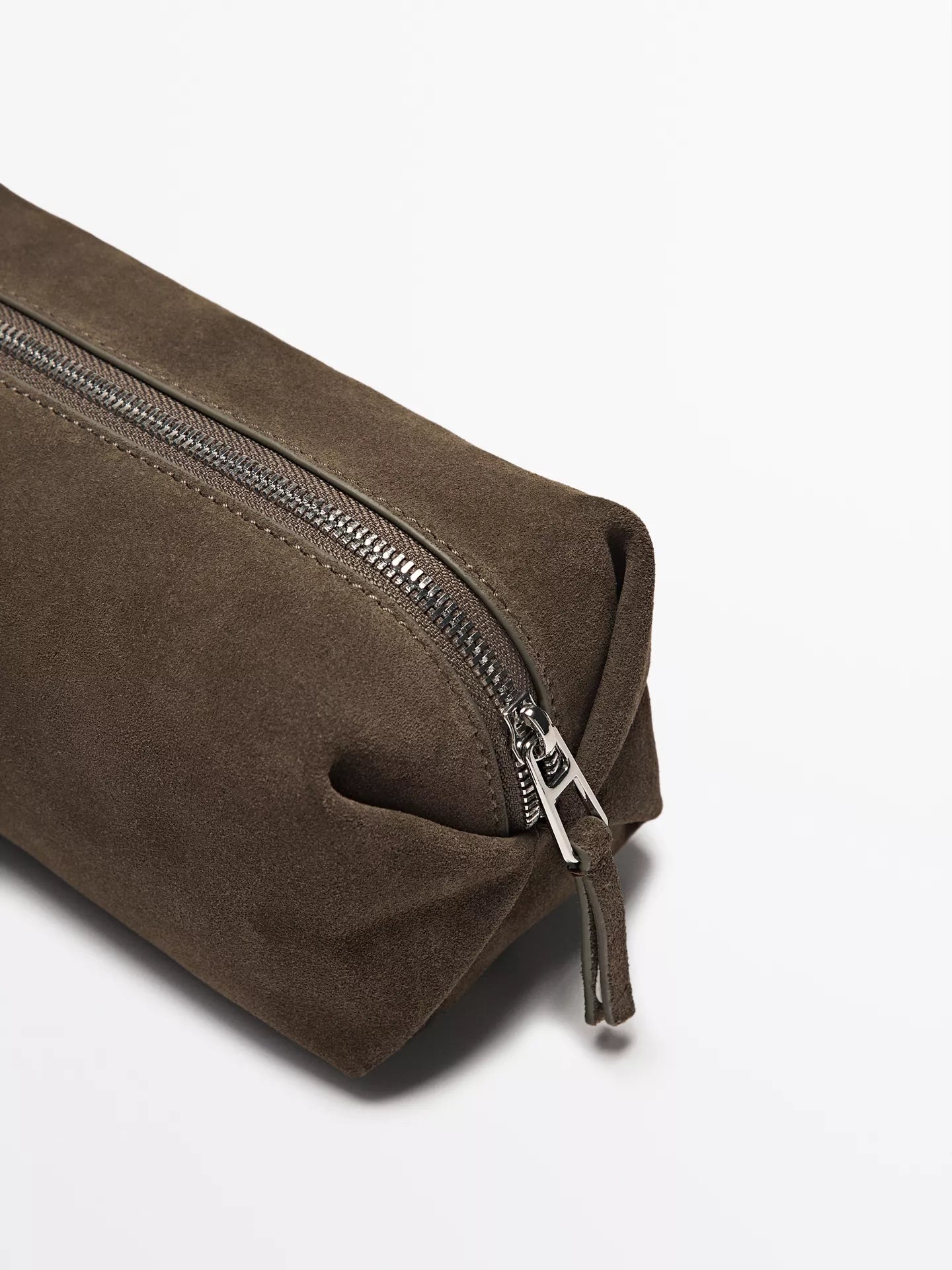 Brown suede toiletry bag with a silver zipper on a white background
