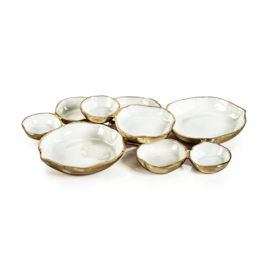 Zodax cluster of nine round serving bowls in gold with white enamel on white background